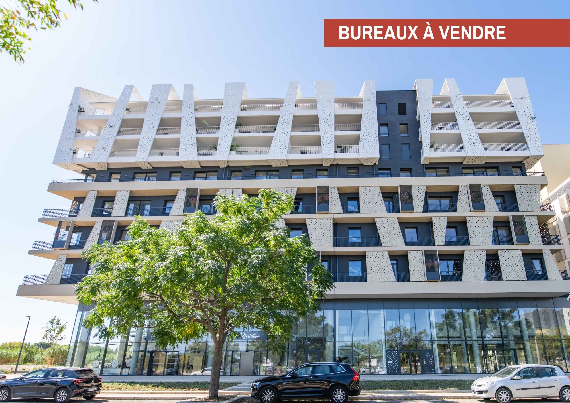 Vue extérieure du programme Skylab, immeuble contemporain avec bureaux à vendre en rez-de-chaussée et façade aux lignes architecturales modernes.
